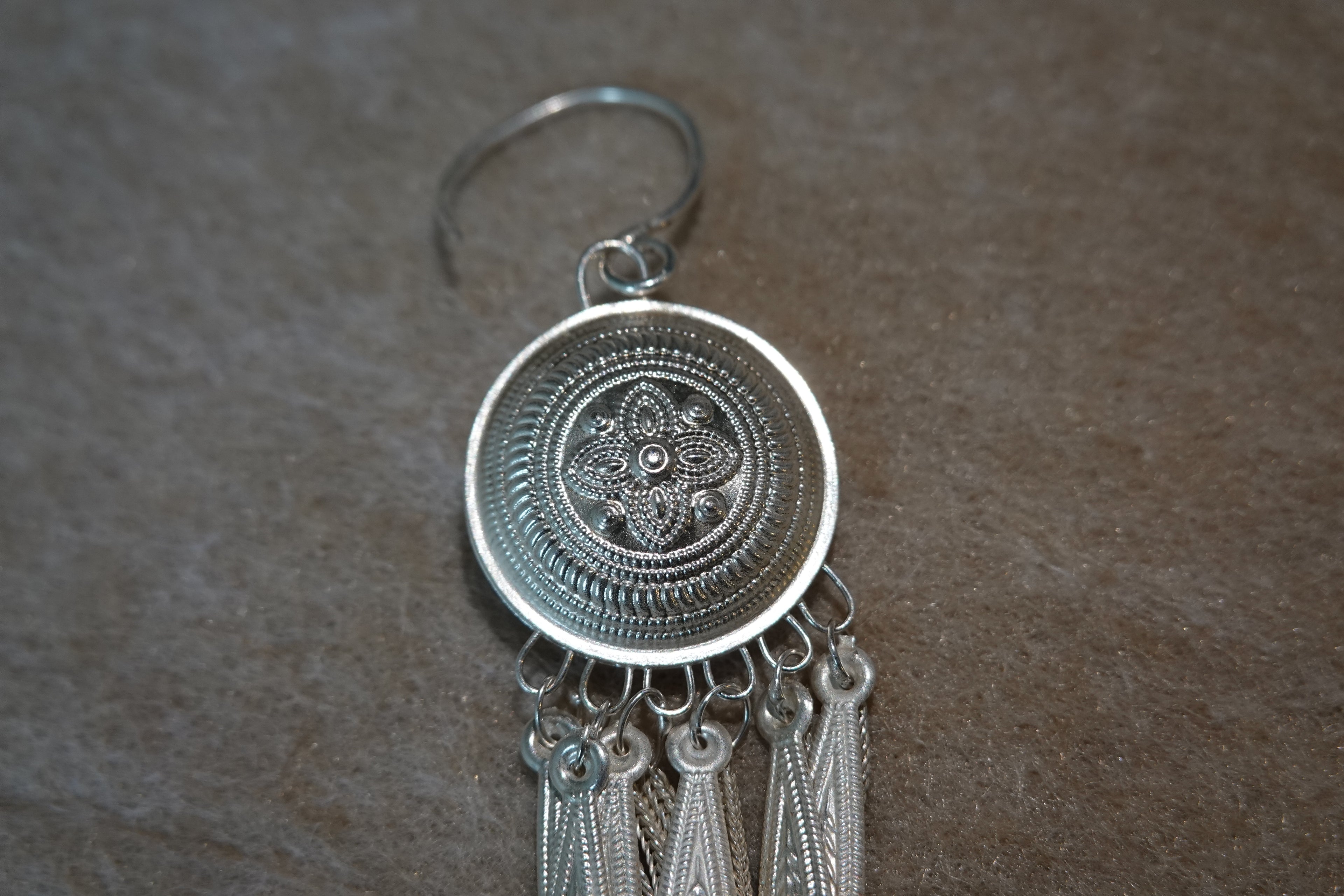 Yi-inspired silver tassel earring with engraved handmade details