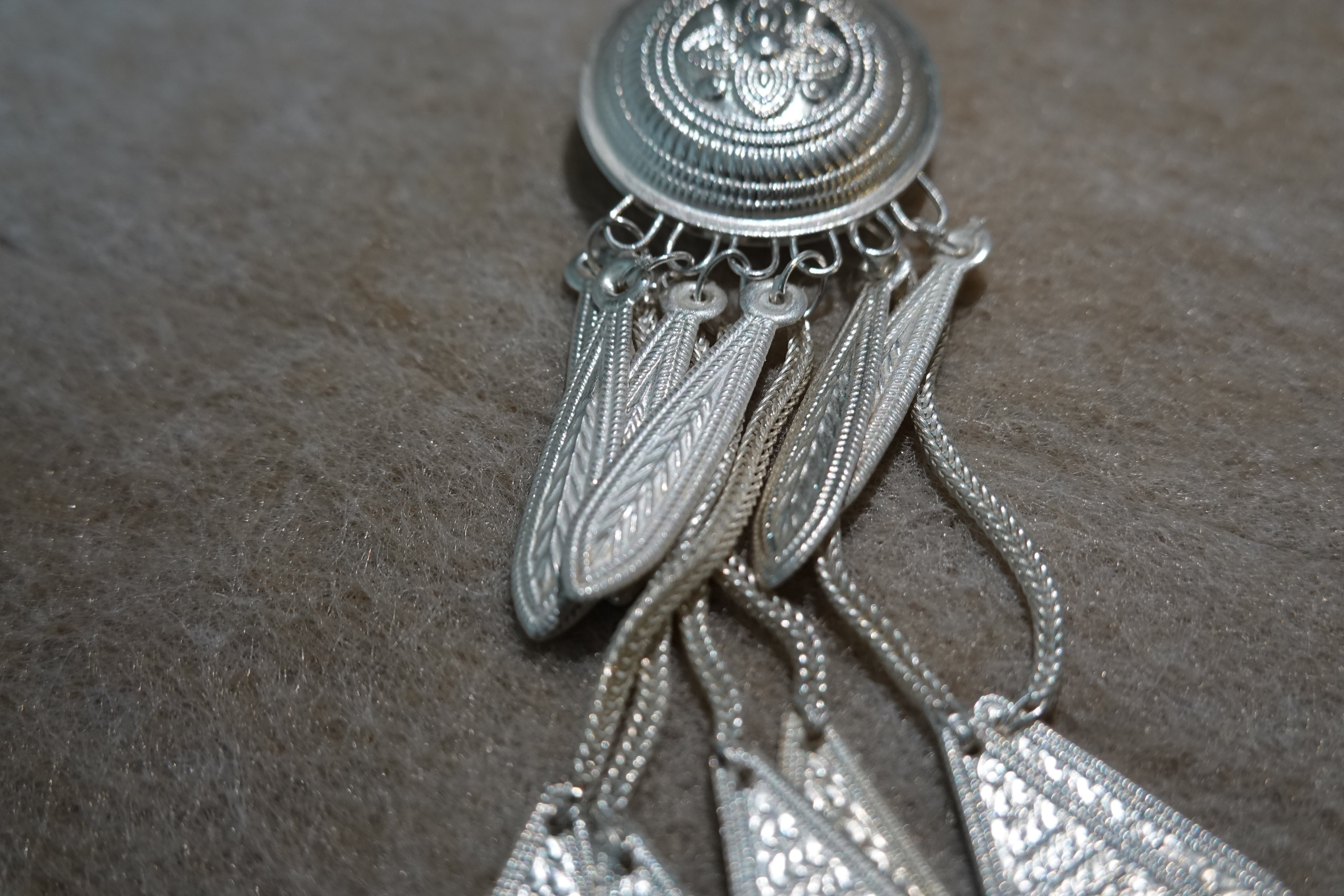 Yi-inspired silver tassel earring with engraved handmade details